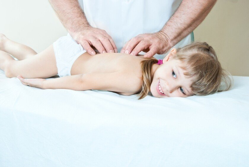 The child is doing massage on the back