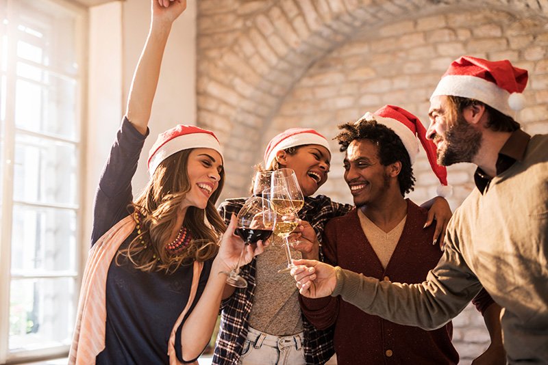 Group of cheerful friends toasting to upcoming New Year.